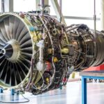 Aircraft jet engine in maintenance facility, representing how MRO management and aircraft maintenance software support inspections, repairs, and compliance tracking.
