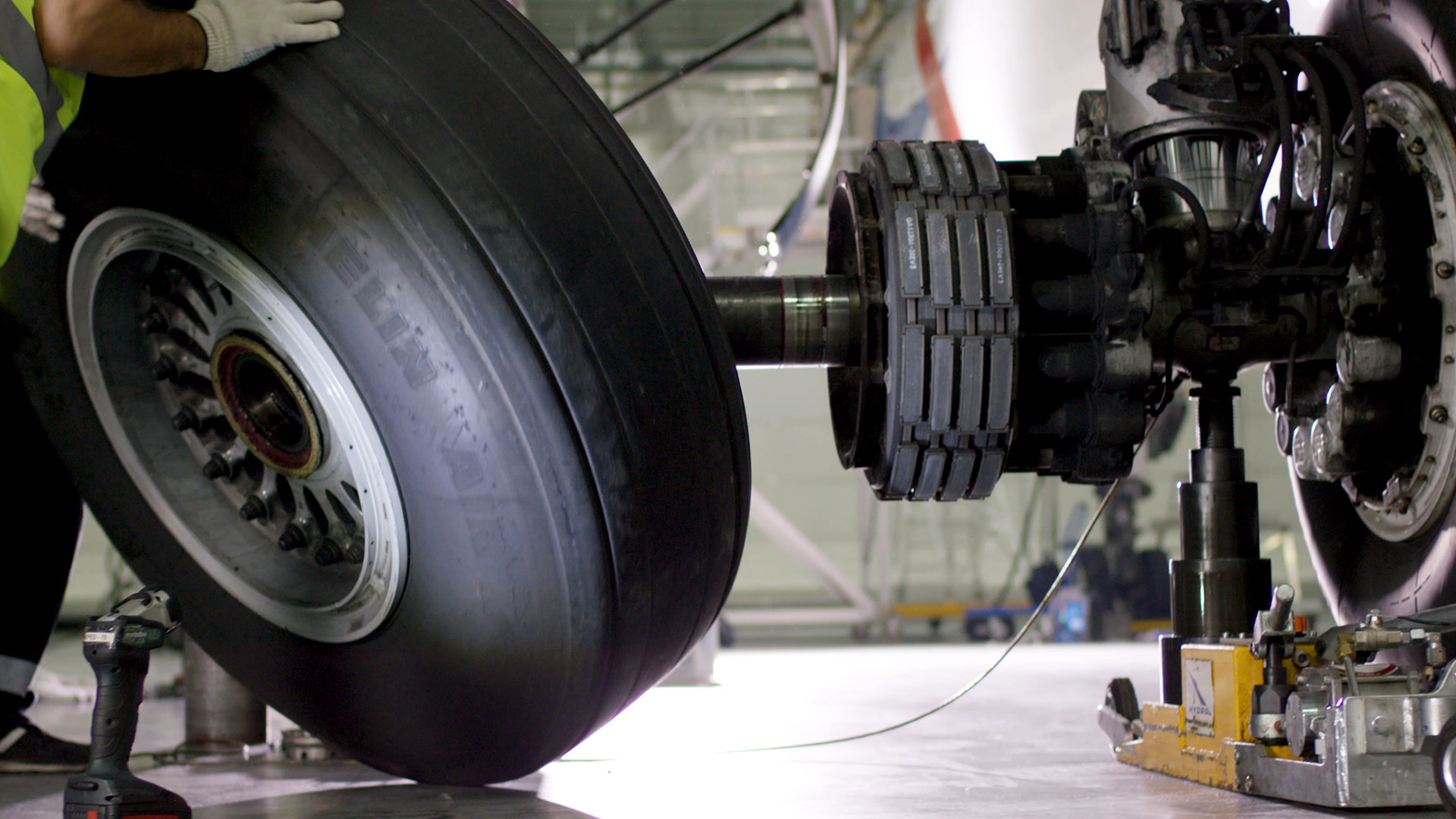 Technician replacing aircraft landing gear wheel, demonstrating how MRO solutions enhance parts traceability, safety compliance, and efficient maintenance operations.